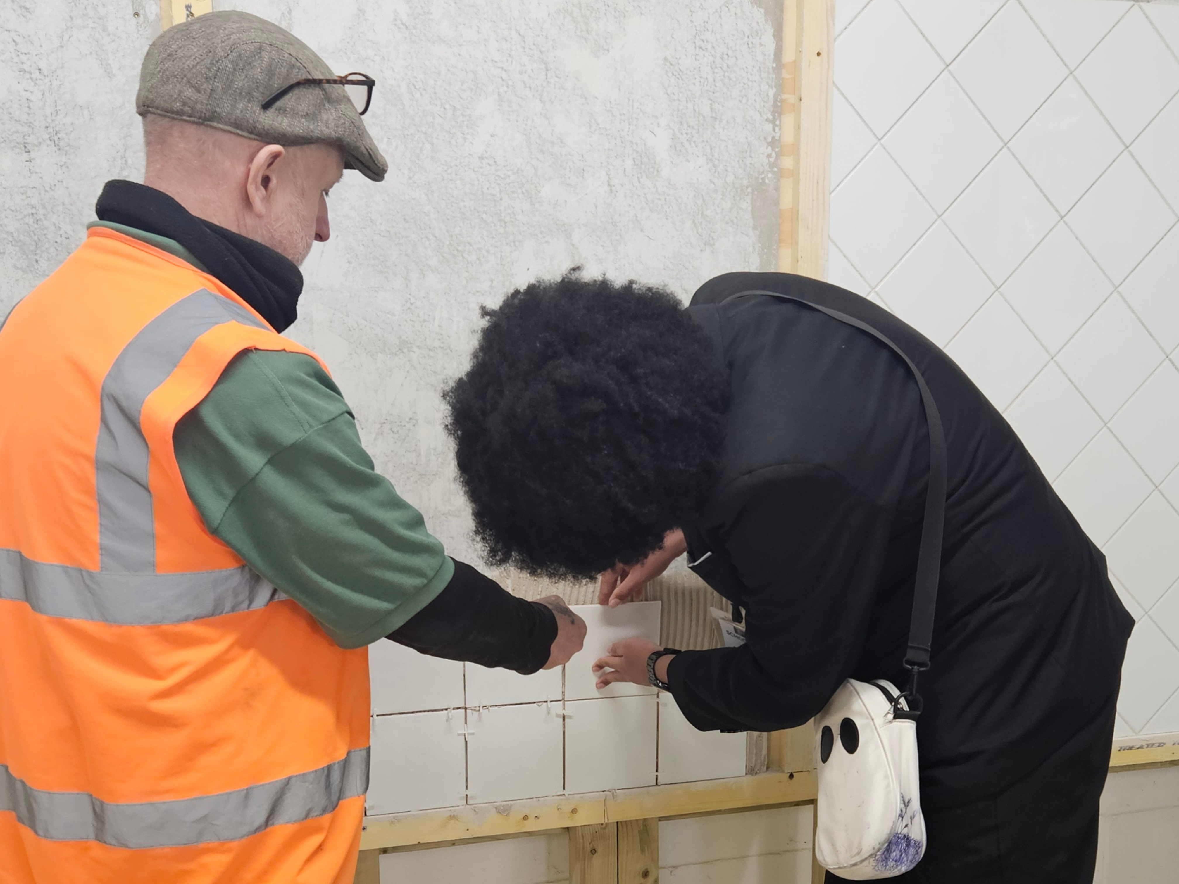 Student laying brick