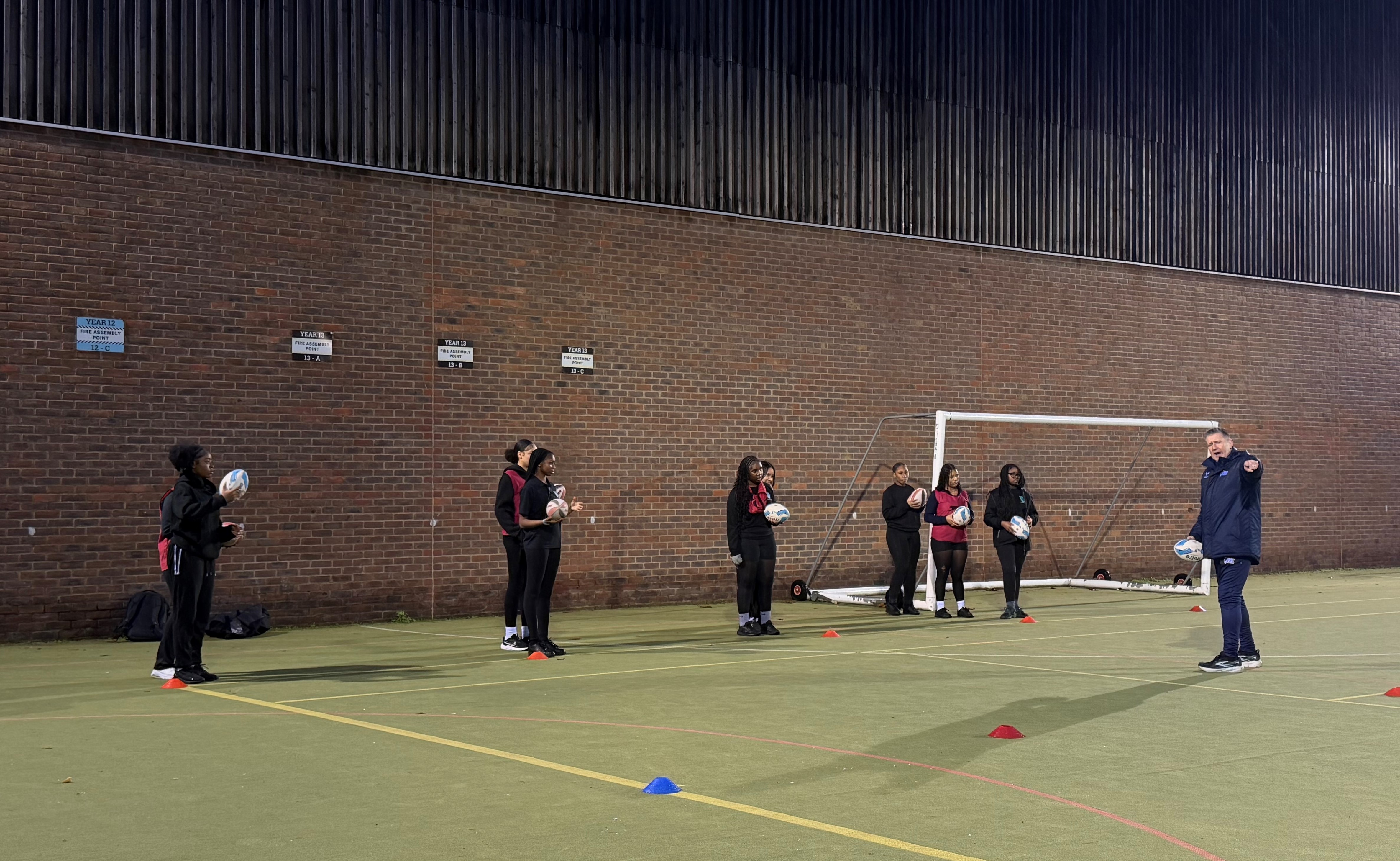 Year 10 Girls getting rugby training from coach