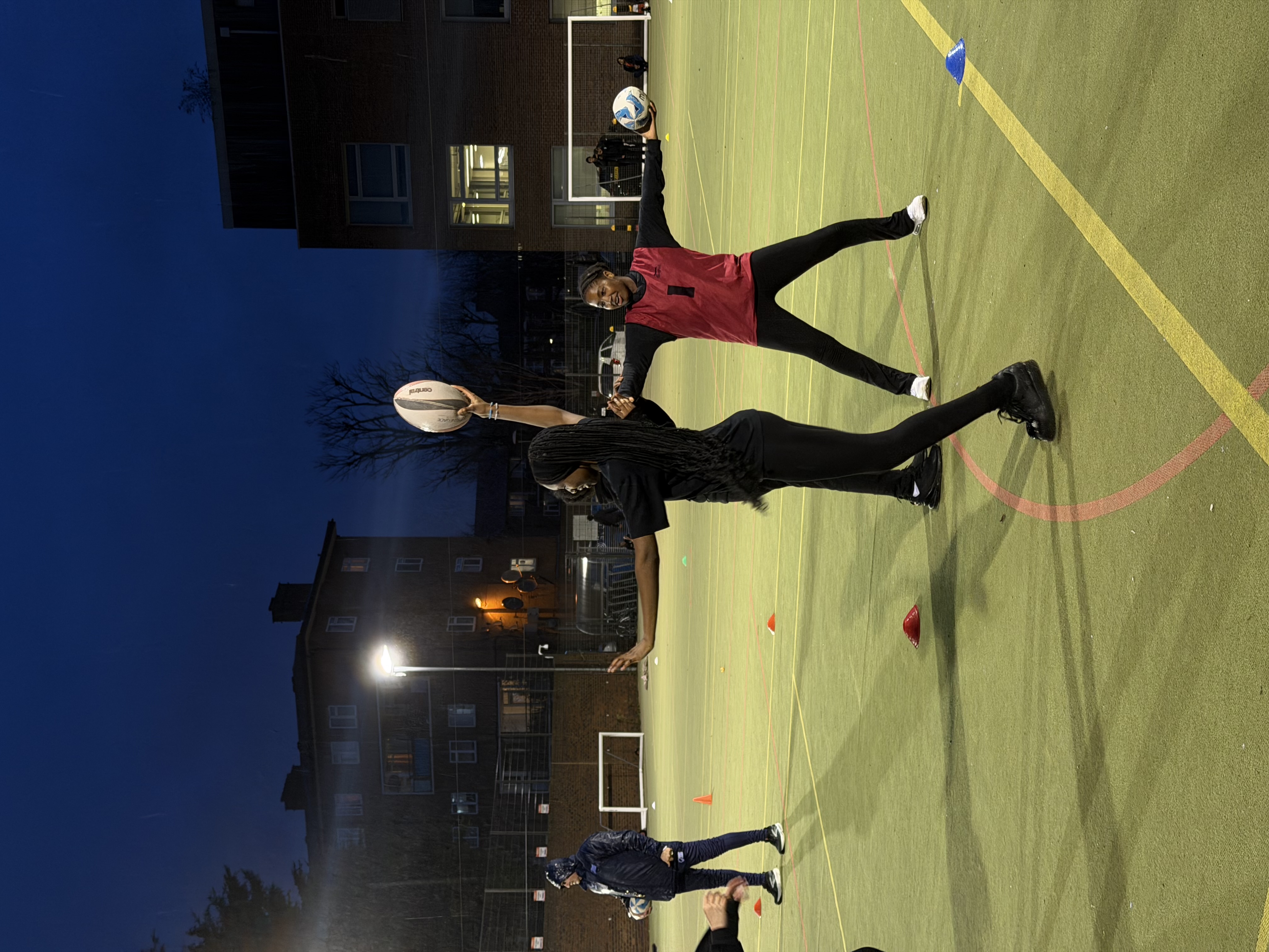 Students trying to grab the ball away from one another