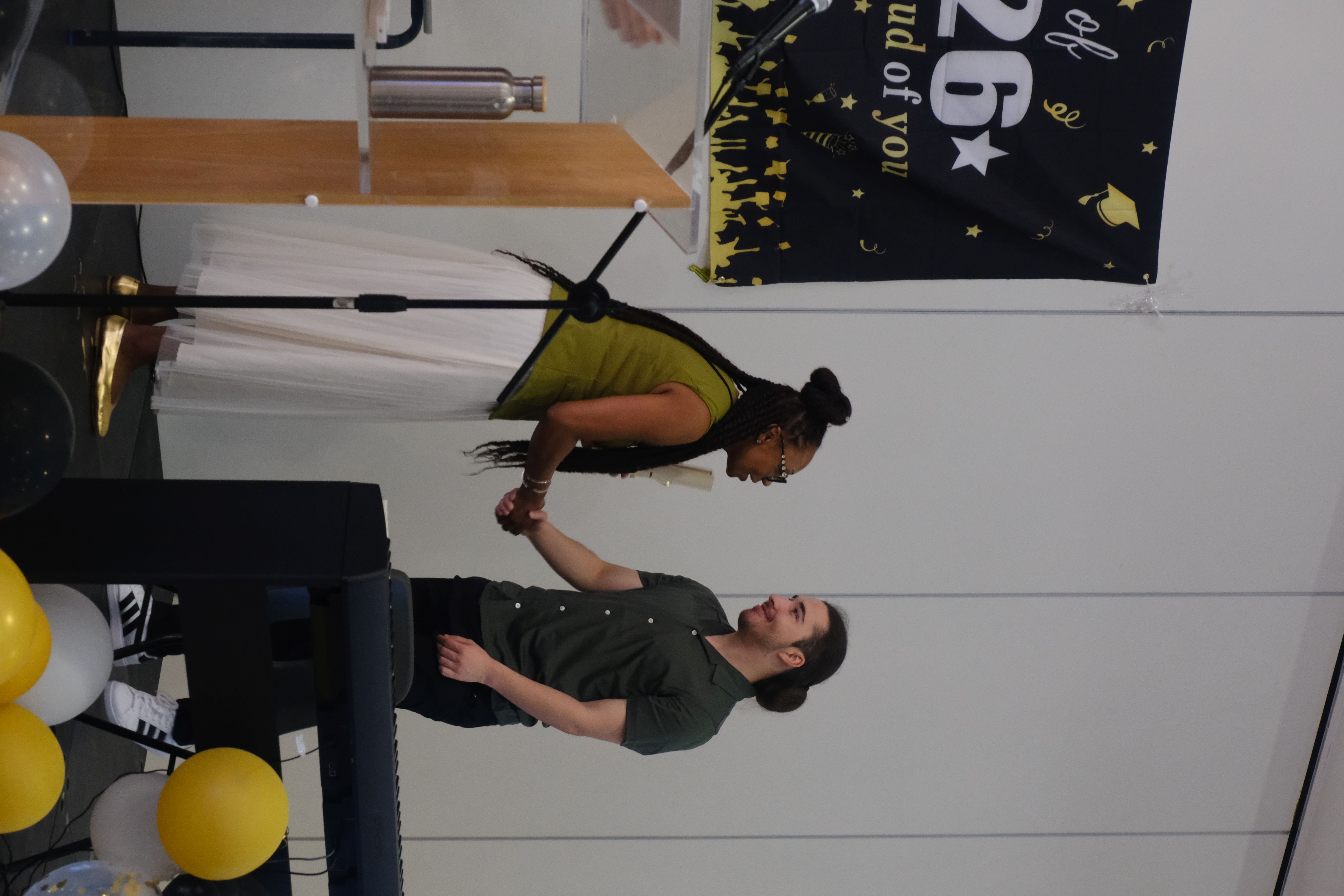 Student smiles and receive graduation certificate