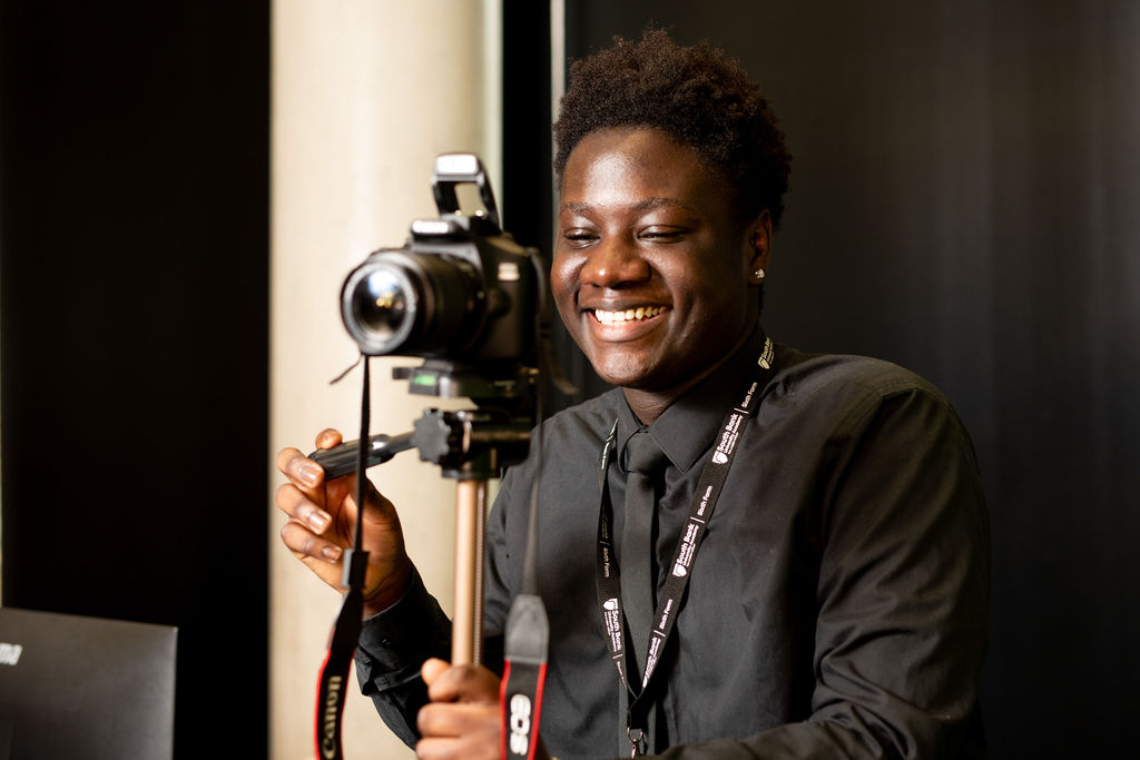 Student smiling behind the camera