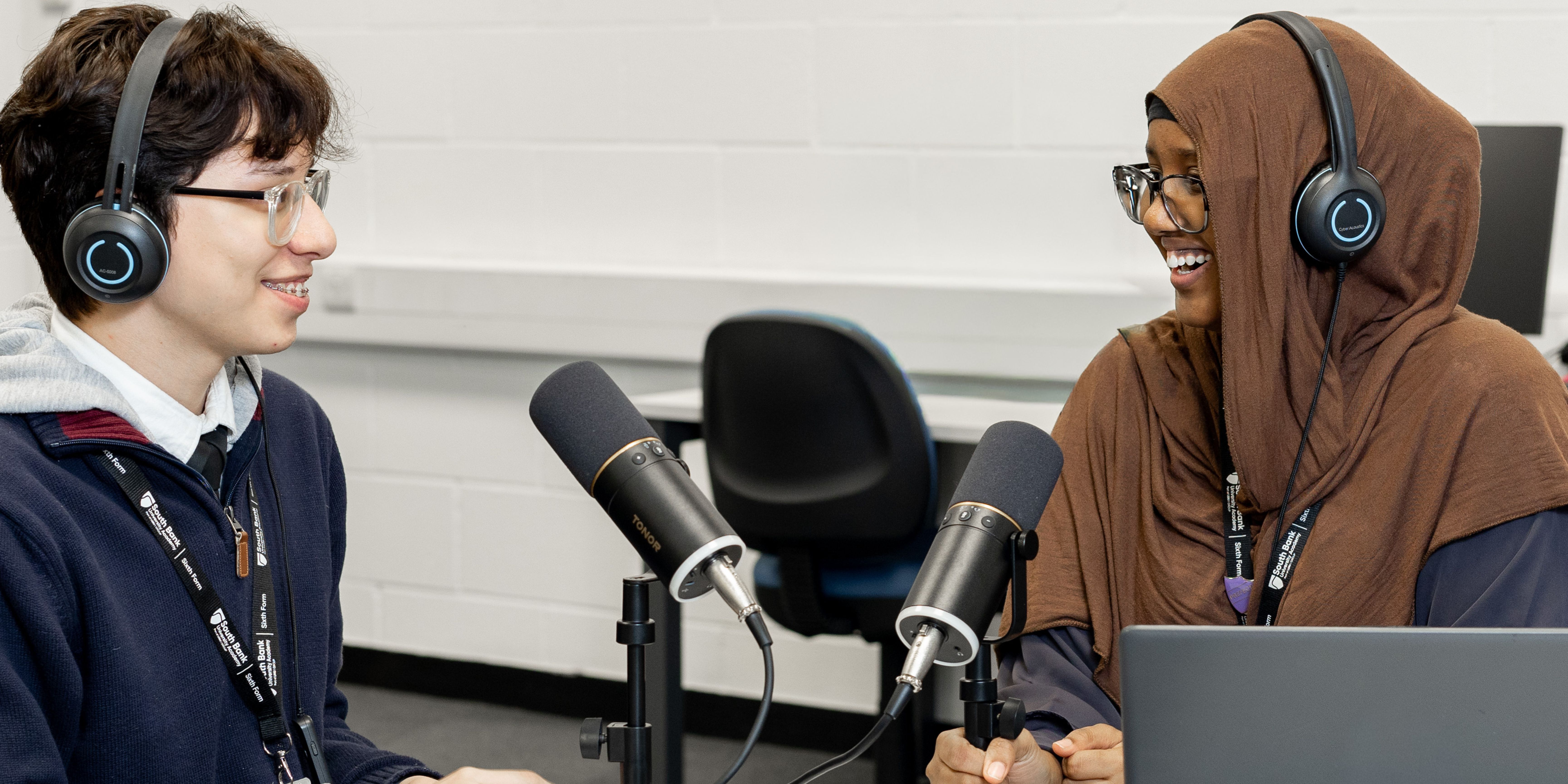 Banner image of students in a broadcast session with mics and headphones