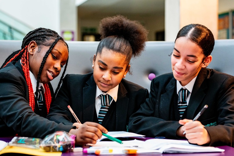 Three student working on their work together