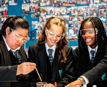 Three students working on science experiment