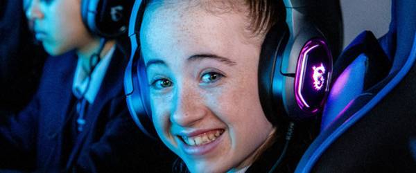 Sminiling student wearing gaming headset