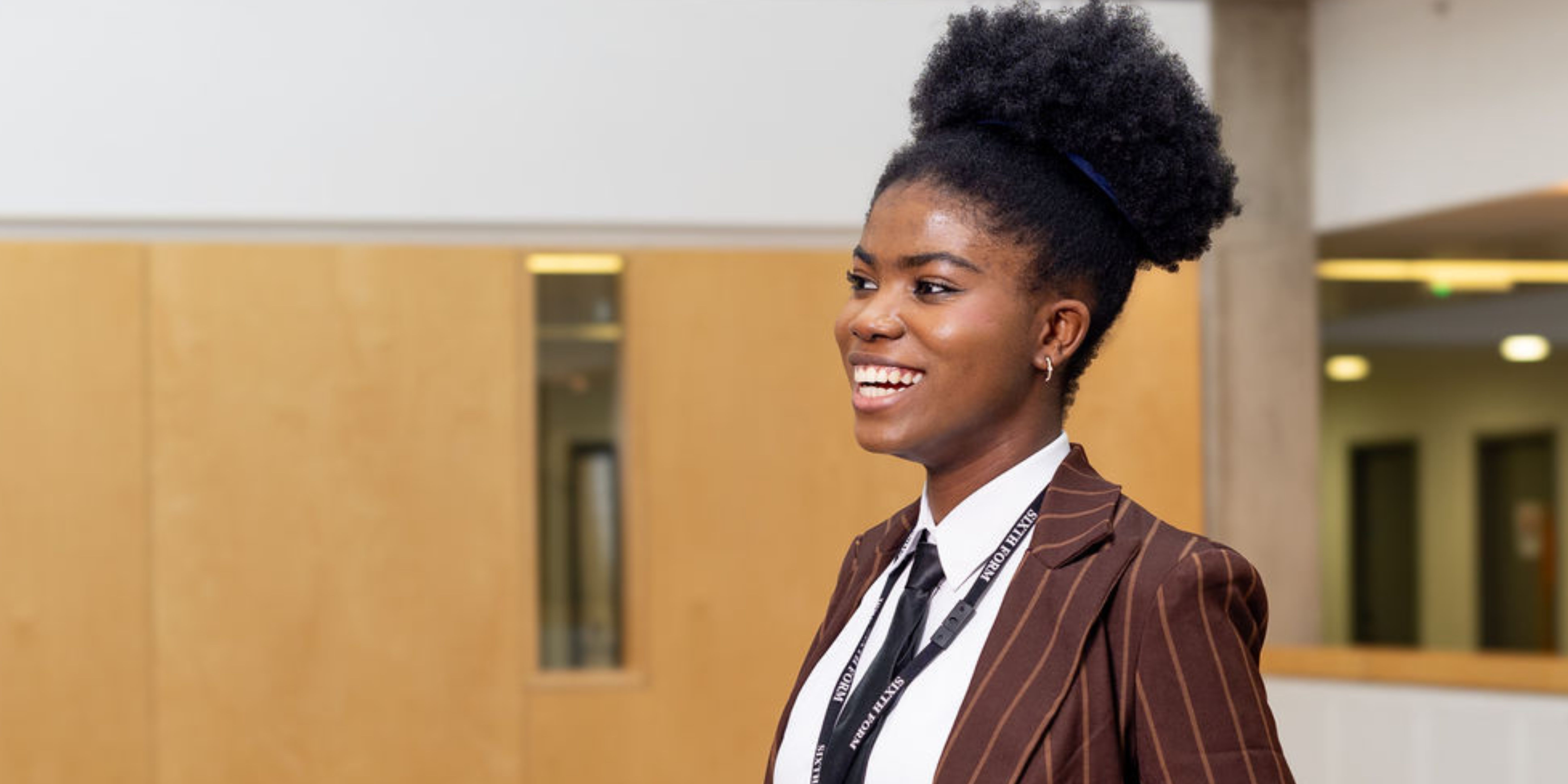 Student in a suit smiling