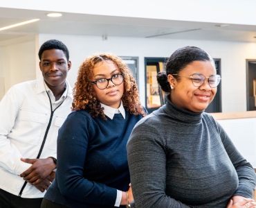Three students standing next to each other