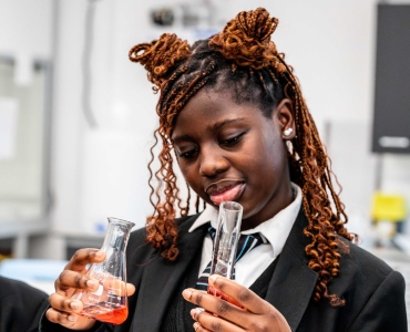 Student holding flask and test tube